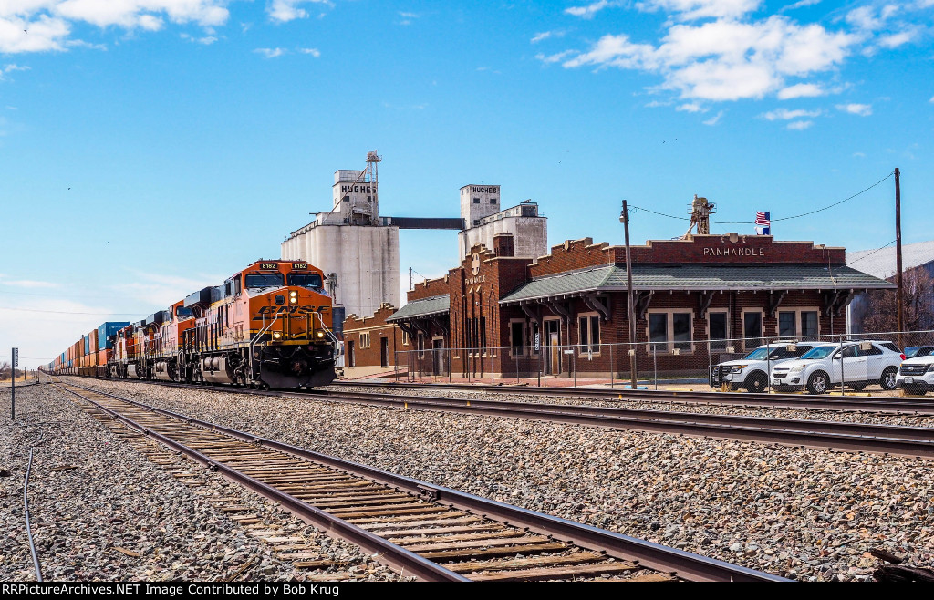 BNSF 8182 leads eastbound stacks past the ex-ATSF depot in Panhandle, TX